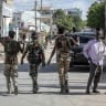 Somali government forces patrol a street as residents gather following reported shelling in the Howl Wadaag district of Mogadishu, on June 4, 2026.