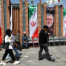 People walk past a banner with a picture of the late Islamic Revolutionary Guard Corps (IRGC) commander Mohammad Pakpour, in Tehran Bazaar, Iran, April 21, 2026