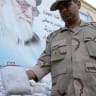 An Iranian policeman holds up a package of seized Afghan-made drugs during a media tour in the southeastern city of Zahedan, on July 19, 2011; illustrative