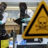Employees of the Research Institute for Protective Technologies, Nuclear, Biological and Chemical Protection (WIS) inspect a dummy sample which is contaminated with a substance similar to the chemical weapon Sarin, during a demonstration in Munster October 15, 2013.