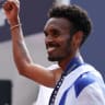 GASHAU AYALE celebrates while draped in the Israeli flag after winning the bronze medal in the marathon and helping Israel capture the European men’s team title. 
