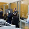 Defendants Daniil B., Vladyslav T. and Yevhen B. cover their faces as they arrive in the courtroom, where a court is expected to conclude the trial against the three Ukrainian nationals suspected of conspiracy to commit arson attacks on behalf of a Russian intelligence service.
