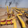 A worker checks an oil pipeline at Nahr Bin Umar oil field, north of Basra, Iraq March 22, 2022.