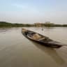 Men extract sand used for construction from the Sokoto river and place it on their boat in Argungu in northern Nigeria, on April 11, 2025