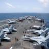 US Sailors work on the flight deck of USS George Washington, Aug. 20, as the aircraft carrier transits the Arabian Sea. 