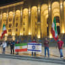 IRANIAN ACTIVISTS display the Lion and Sun flag alongside Israel’s flag outside Georgia’s parliament at one of the rallies that interviewee Behnam Vali Heydarian says he was pressured to stop organizing.