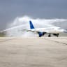 A Syrian Airlines passenger jet, the first aircraft to land at Aleppo airport after it was shut during the offensive that toppled president Bashar al-Assad, receives a water salute upon arrival on March 18, 2025.