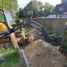 A tractor which drove over graves, smashed gravestones, and dug directly into graves in the Brzesko cemetery in Poland.