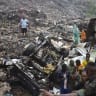 People gather at a landfill after a landslide, triggered by heavy overnight rains, killed several people in Dar es Salam in Conakry, Guinea, August 23, 2026.