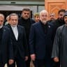 Iranian Foreign Minister Abbas Araghchi (2nd L), Iranian parliament speaker Mohammad Bagher Ghalibaf (2nd R), and Omani Foreign Minister Badr bin Hamad Al Busaidi (R) walk inside a building in Muscat, Oman, on June 22, 2026. 