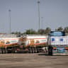 Trucks loaded with humanitarian aid wait at the Kerem Shalom crossing before entering the Gaza Strip from southern Israel, August 12, 2026. 
