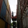 An employee uses a hydraulic lift to check the number of containers at Thar Dry Port in Sanand in the western Indian state of Gujarat, July 15, 2026.