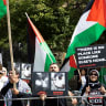 Pro-Palestinian protestors wave flags and signs across the street of the Roy Thomson Hall where the documentary "The Road Between Us: The Ultimate Rescue" is screened during the Toronto International Film Festival (TIFF) in Toronto, Ontario, on September 10, 2025; illustrative