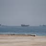 Vessels near the Strait of Hormuz, as seen from Musandam, Oman, August 24, 2026. 