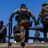Immigration and Customs Enforcement (ICE) agents walk outside the Ventura County Government Center in Ventura, California, on July 27, 2026; illustrative.