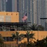 The US flag flutters outside the US Embassy, seen across the Tigris River in Baghdad's fortified Green Zone on March 17, 2026.