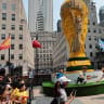 Fans take pictures with a Lego World Cup trophy as they attend a watch party for the France vs Spain FIFA World Cup Semifinal match at Rockefeller Center on July 14, 2026 in New York City.