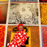 Artist Yayoi Kusama poses for a photograph with her artwork "Love arrives at the Earth Carrying with it a Tale of the Cosmos" at the Tate Modern gallery in London
