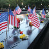 AMERICAN FLAGS and flowers mark victims’ names at the 9/11 Memorial and Museum in New York City. Families say the site is sacred ground that should be a place of mourning, not a ground for political division. 