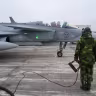 A member of the ground crew of the Swedish Air Force stands next to a JAS 39 Gripen fighter aircraft in Kallinge, Sweden, December 16, 2025.