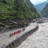 A drone view of firefighters conducting search and rescue operations at a damaged road leading to Gyirong Port after a mudslide, in Gyirong county, Shigatse, Tibet Autonomous Region, China August 28, 2026.
