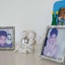A figurine depicting two angels in Inger Platou's home next to framed photographs of Inger's adopted sons, Gregorios and Daniel (then called Juan and Marcos) in her home in Nuuk, Greenland, May 25, 2026. 
