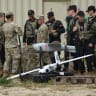 Members of the US Army 7th Army Training Command stand among fixed-wing reconnaissance drones during the Saber Junction 26 combined military exercise at the US Army Joint Multinational Readiness Center on August 26, 2026, near Hohenfels, Germany.
