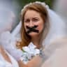 Advocates and child marriage survivors from the group "Unchained at Last" put on wedding gowns, veils, chains and tape over their mouths as they gather on Boston Common before marching to the State House to call for an end to child marriages in Boston, Massachusetts on September 22, 2021.