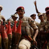 Sudan's paramilitary Rapid Support Forces (RSF) soldiers greet people as they secure a site where Lieutenant General Mohamed Hamdan Dagalo, deputy head of the military council and head of RSF, attends a meeting in Khartoum, Sudan, June 18, 2019. 