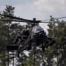 A Polish Air Forces US-made AH-6h Apache helicopter participates in a lake crossing, as troops from Poland and Lithuania take part in the "Bursztynowy Obronca-26" (Amber Defender) military exercise on the Orzysz military training ground, north-eastern Poland, on June 24, 2026.