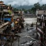 A drone view shows a man walking next to damaged buildings and houses covered in mud next to the Likhu River following deadly flash floods and mudslides, in Devighat, Nuwakot district, Nepal, August 30, 2026.
