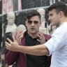 Martin Sellner (L), Austrian far-right political activist, poses for a selfie with Italian activist Andrea Ballarati in front of a controversial monument dedicated to antisemitic former Viennese mayor Karl Lueger, as he takes part in a rally of the far-right Identitarian Movement Austria in Vienna.