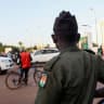 A security officer stands guard on the street following a mutineers' attack on the airport and the presidency in Niamey, Niger, August 29, 2026.