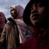 Woman and children receive traditional sweets as they attend Eid al-Fitr prayers at Brooklyn's Prospect Park on March 20, 2026, in New York City.