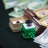 An Aqeeq (agate) ring is pictured next to Iraqi dinar and US dollar banknotes are laid out on a table as members of the Shia Muslim community arrive at a centre in Iraq's southern city of Basra accepting charity donations to aid people affected by the ongoing war in Iran and Lebanon.