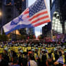 Pro-Israel counter-protesters stand in front of police separating them from pro-Palestinian protesters near the Israeli consulate, during the Democratic National Convention (DNC), in Chicago, Illinois, US, August 20, 2024.