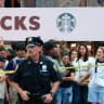 A member of the NYPD stands guard as people gather at the scene of an officer-involved shooting, in Times Square, New York City, US, August 31, 2026. 
