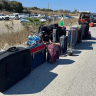 Among the items at a market in Cyprus, suitcases bearing flight tags and markings related to Ben Gurion Airport.