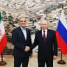 Russia's President Vladimir Putin and Iran's President Masoud Pezeshkian shake hands during a meeting on the sidelines of the Shanghai Cooperation Organisation (SCO) summit in Bishkek on September 1, 2026. 