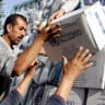 Palestinians receive food aid donated for refugees from the European Union and the World Food Programme (WFP) and distributed by the United Nations Relief and Works Agency (UNRWA) in the northern West Bank city of Jenin, on July 9, 2010.