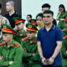 Former police officer Ha Minh Duc (L) and Nguyen Van Hung (2nd R) are seen during a hearing at the People's Court in Hanoi on July 1, 2025. A Vietnam court sentenced 11 people to death on July 2, including two police officers, after finding them guilty of trafficking drugs over the border from Laos.