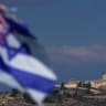 A flag combining the Israeli and American flags flutters in seen in front of a military post in southern Lebanon, as seen from the Israeli side of the border, October 29, 2025