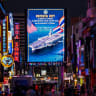 People walk past an LED display welcoming U.S. service personnel from the U.S. Nimitz-class aircraft carrier USS Abraham Lincoln, which is docked at Laem Chabang Port for a rest stop following a long deployment in the Middle East, in Pattaya City, Thailand, September 3, 2026.