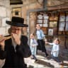 An ultra-Orthodox man blows a shofar ahead of Rosh Hashanah in Mea She’arim in Jerusalem in August