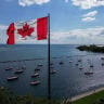 A Canadian flag flies along the waterfront of Lake Ontario, in Toronto, Canada, in August.
