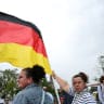 A supporter of the Alternative for Germany (AfD) party holds a German flag as she attends AfD top candidate Ulrich Siegmund's campaign event ahead of the upcoming Saxony-Anhalt state elections in Magdeburg, Germany, September 4, 2026. REUTERS/Annegret Hilse