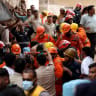 Members of rescue teams carry a victim after a building collapsed in New Delhi, India, September 6, 2026.