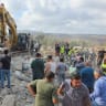 People stand amid rubble as heavy machinery operates at the site of an Israeli strike, in Arab Salim, Lebanon, September 6 , 2026. Picture taken with a mobile phone. 