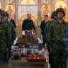 Serbian armed forces stand guard as Darko Mladic stands in front of the coffin of his father while taking part in a public memorial on the day of the funeral ceremony for late Bosnian Serb military leader Ratko Mladic at St Lukas church in Belgrade, on September 7, 2026.