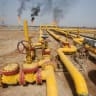 A worker checks an oil pipeline at Nahr Bin Umar oil field, north of Basra, Iraq.